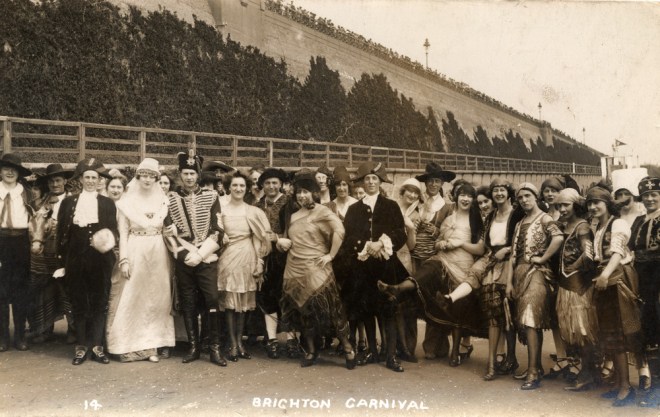 Brighton carnival in front of Madeira Drive green wall. Royal Pavilion & Museums, Brighton & Hove