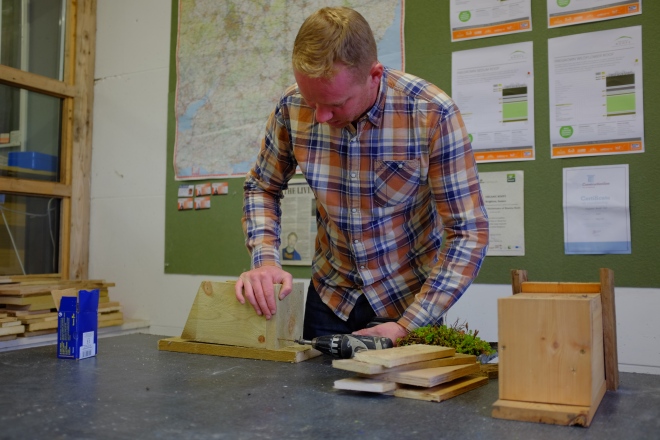 Lee Evans, course tutor, demonstrating how to build the bird box to the course participants.